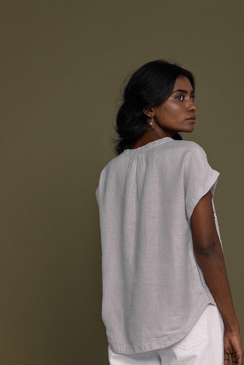 cloud grey embroidered top with side pockets.