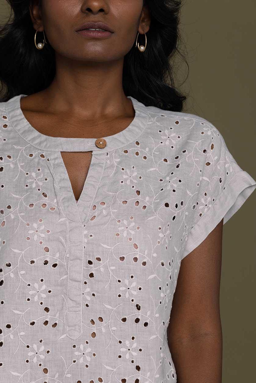 cloud grey embroidered top with side pockets.