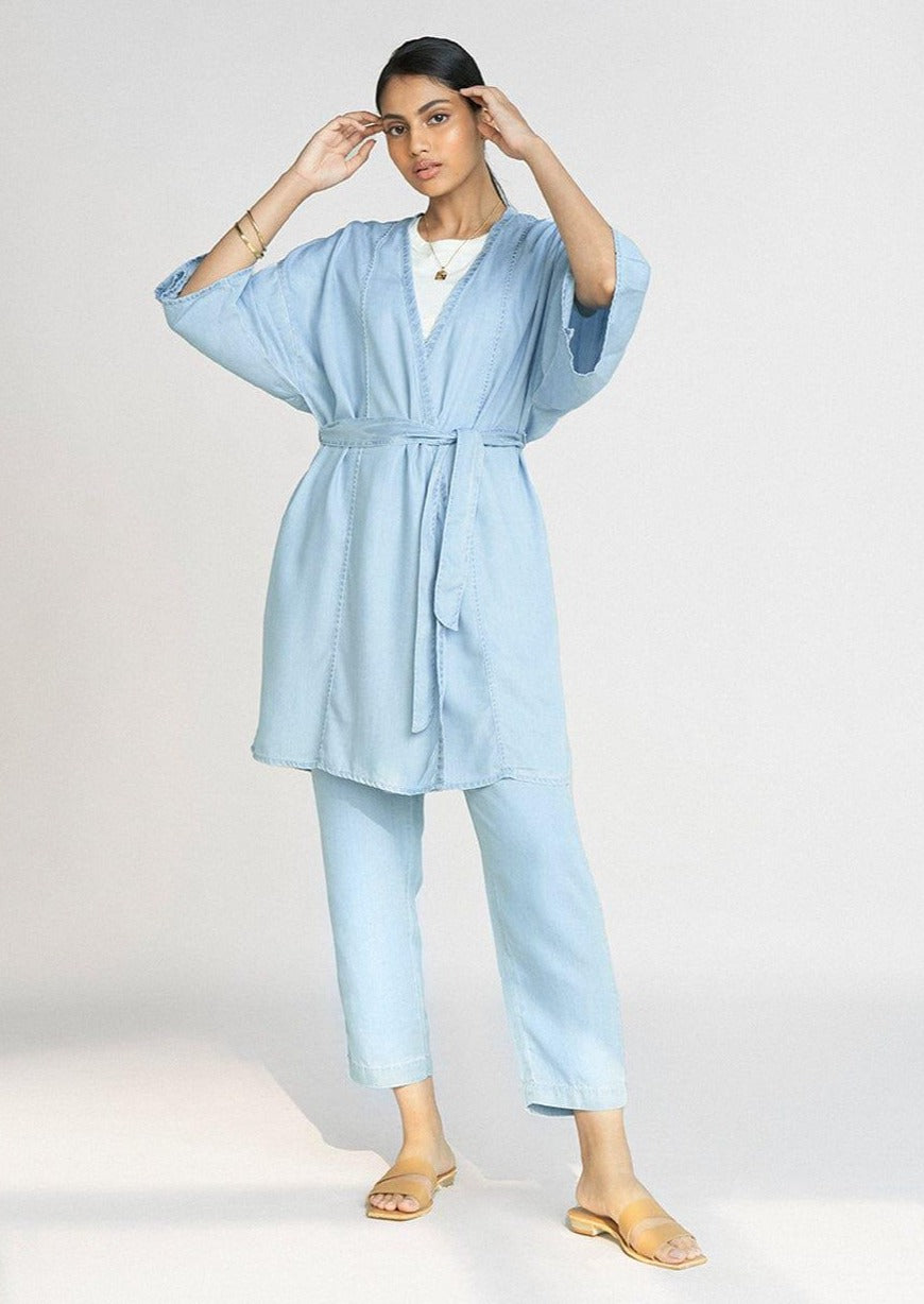 Full-length view of the Reistor Wrapped in Happiness Overlay in Ocean Blue, featuring a tie-waist design, relaxed kimono sleeves and lightweight fabric.