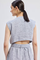 Reisto.r Back Cut Out Linen Dress in grey, close-up back view showing the signature cut-out detail, breathable textured linen fabric, and adjustable waist tie.