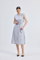 Model wearing reistor Back Cut Out Linen Dress in soft grey, sleeveless button-front linen midi dress with adjustable waist tie and relaxed fit.