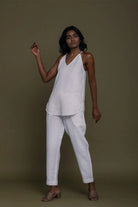 Reistor sleeveless white co-ord set with V-neck top and tapered pants, sustainable women's fashion with a relaxed fit.
