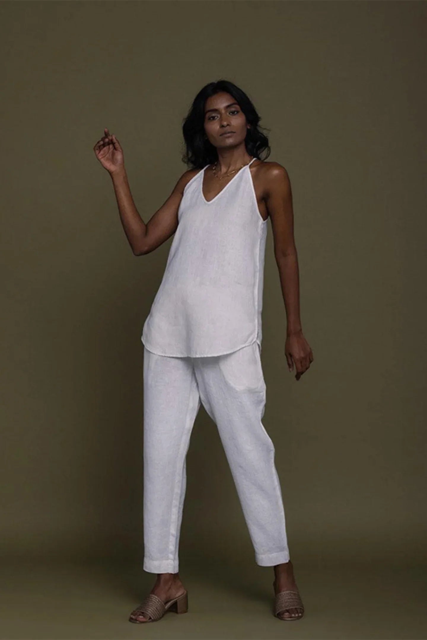 Reistor sleeveless white co-ord set with V-neck top and tapered pants, sustainable women's fashion with a relaxed fit.