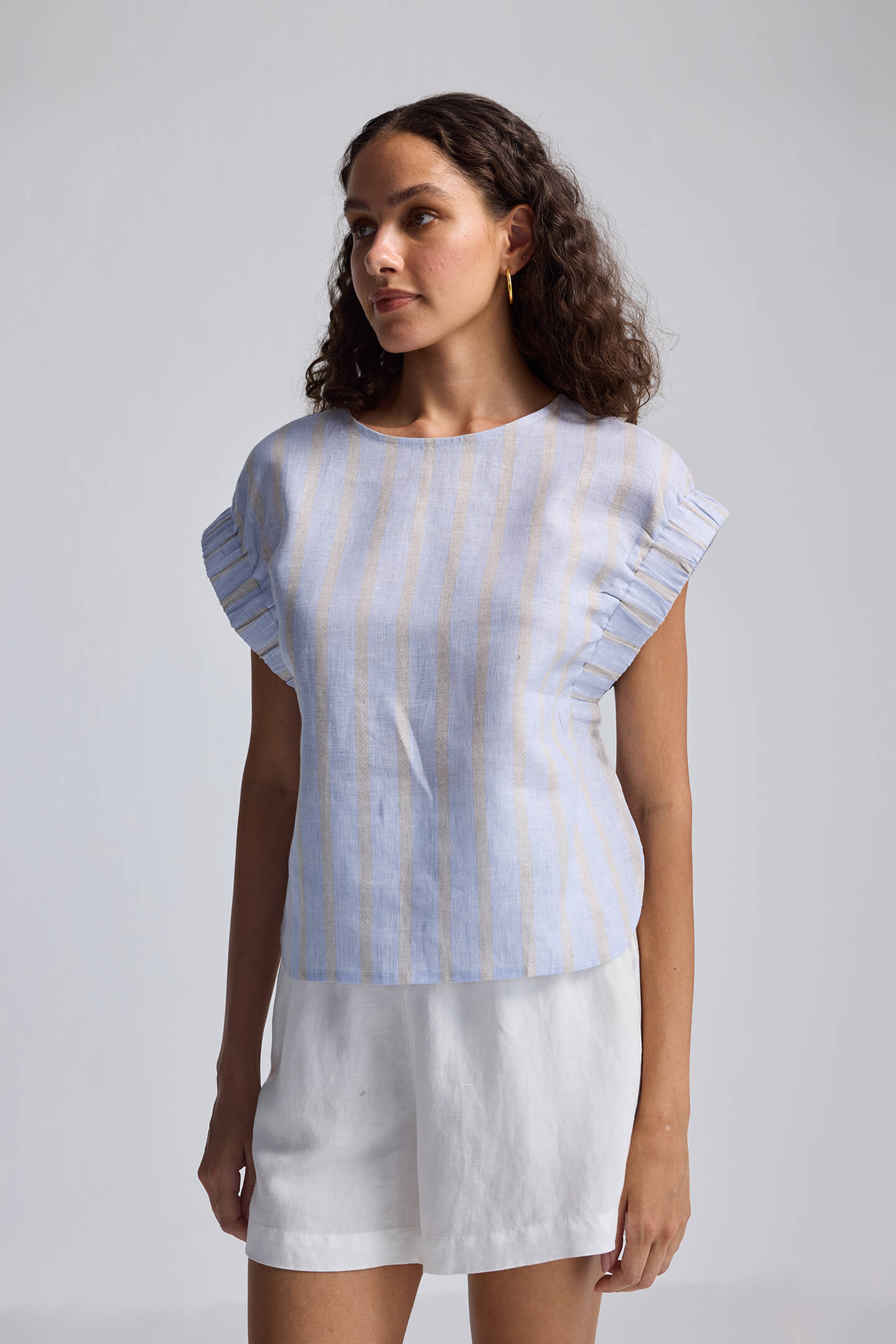 Rear view of the reistor Boxy Top with Sleeve Detailing featuring light blue and beige vertical stripes and a back button-loop closure.