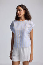 Rear view of the reistor Boxy Top with Sleeve Detailing featuring light blue and beige vertical stripes and a back button-loop closure.