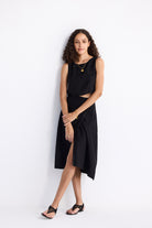 Front view of model wearing Reistor Breezy Summer Set in Black, featuring a sleeveless crop top and high-waisted midi skirt with a relaxed, airy summer silhouette.