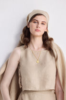 Reistor Breezy Summer Set in Neutral Beige worn by a female model, sleeveless beige top with matching skirt styled for a minimalist sustainable summer look