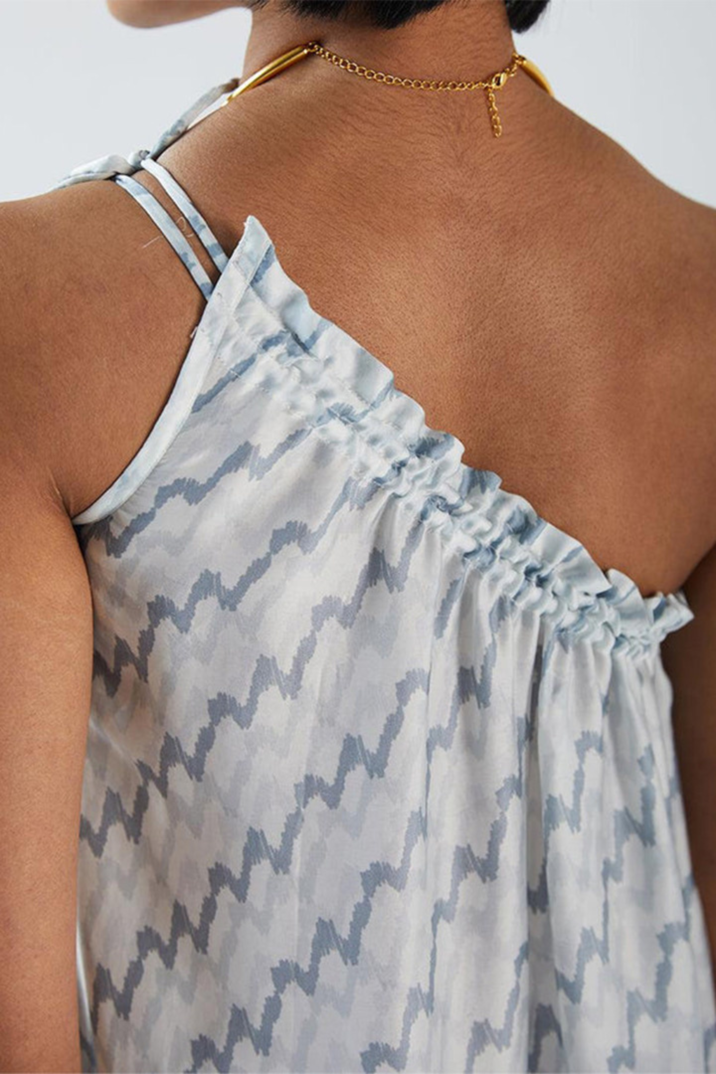 Back view of Reistor Dancing in the Moonlight Dress, a light blue patterned dress with thin straps, offering a breezy, sustainable style for warm-weather days.