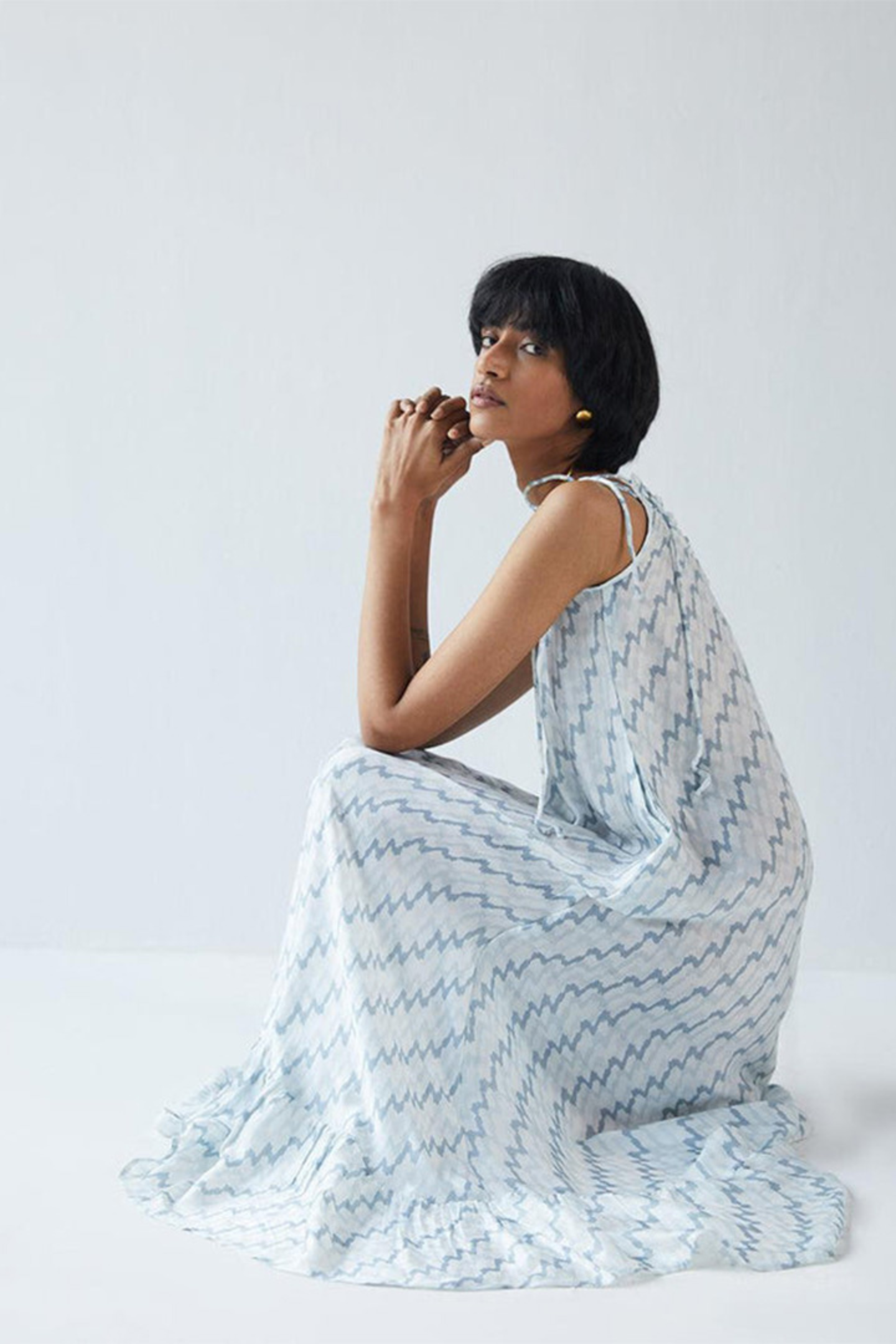 Woman wearing Reistor Dancing in the Moonlight Dress, a flowing sustainable dress with a relaxed silhouette, perfect for elegant daytime outings and summer style.