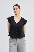 Deep V-neck short top in Black by reistor with cap sleeves, front button closure, and breathable linen fabric in a relaxed fit silhouette for everyday wear.