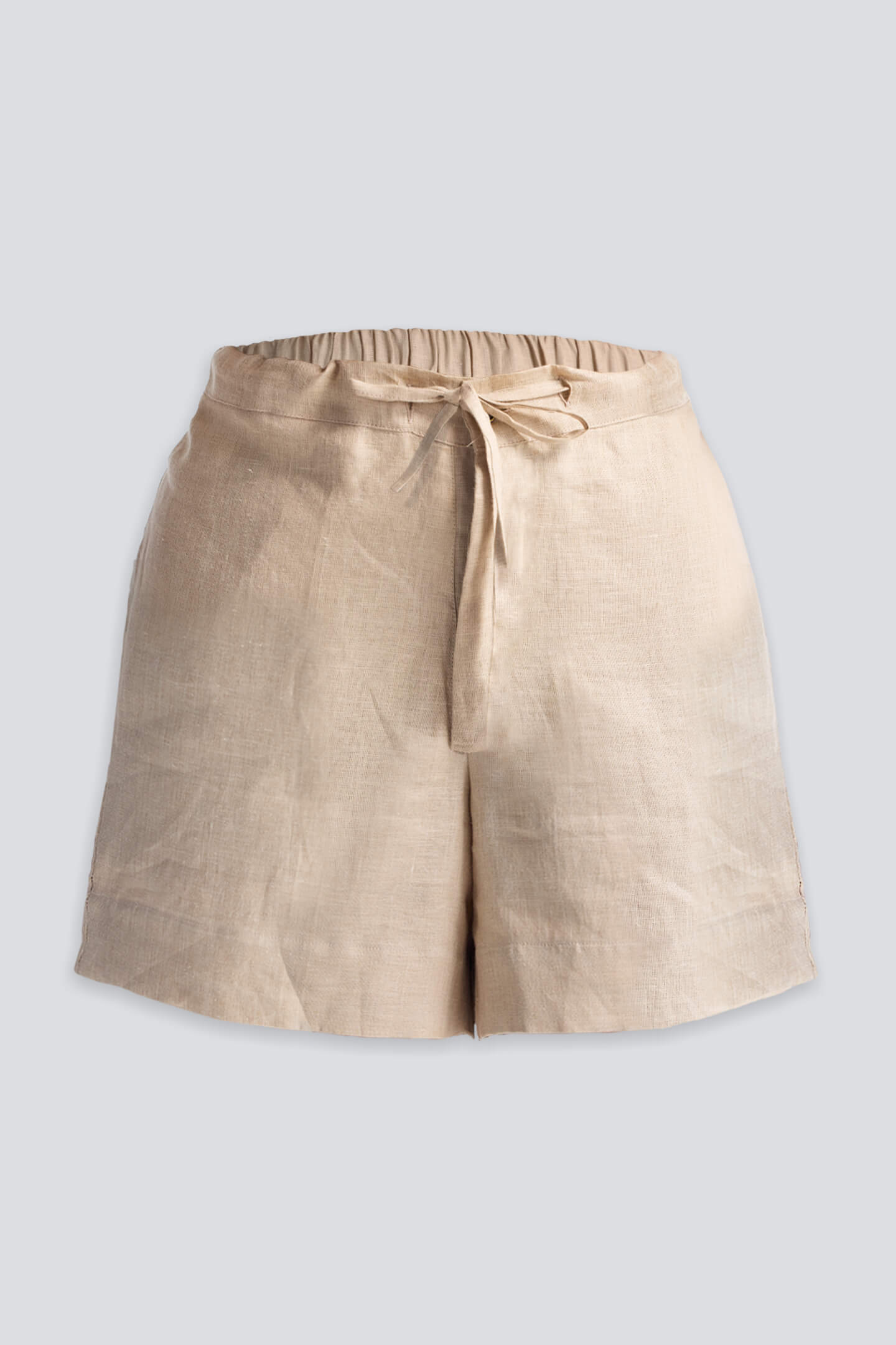 Model showcasing the reistor Boxy Top with Sleeve Detailing in a blue and tan vertical stripe pattern, styled with Drawstring Shorts in Neutral Beige for a relaxed, sustainable summer look.