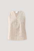 Embroidered Button Front Neck Top in Cream featuring intricate tonal floral embroidery, a sleeveless silhouette, and a V-neckline with pearl-style button-front detailing, displayed on a light background to highlight the textured fabric and elegant design.