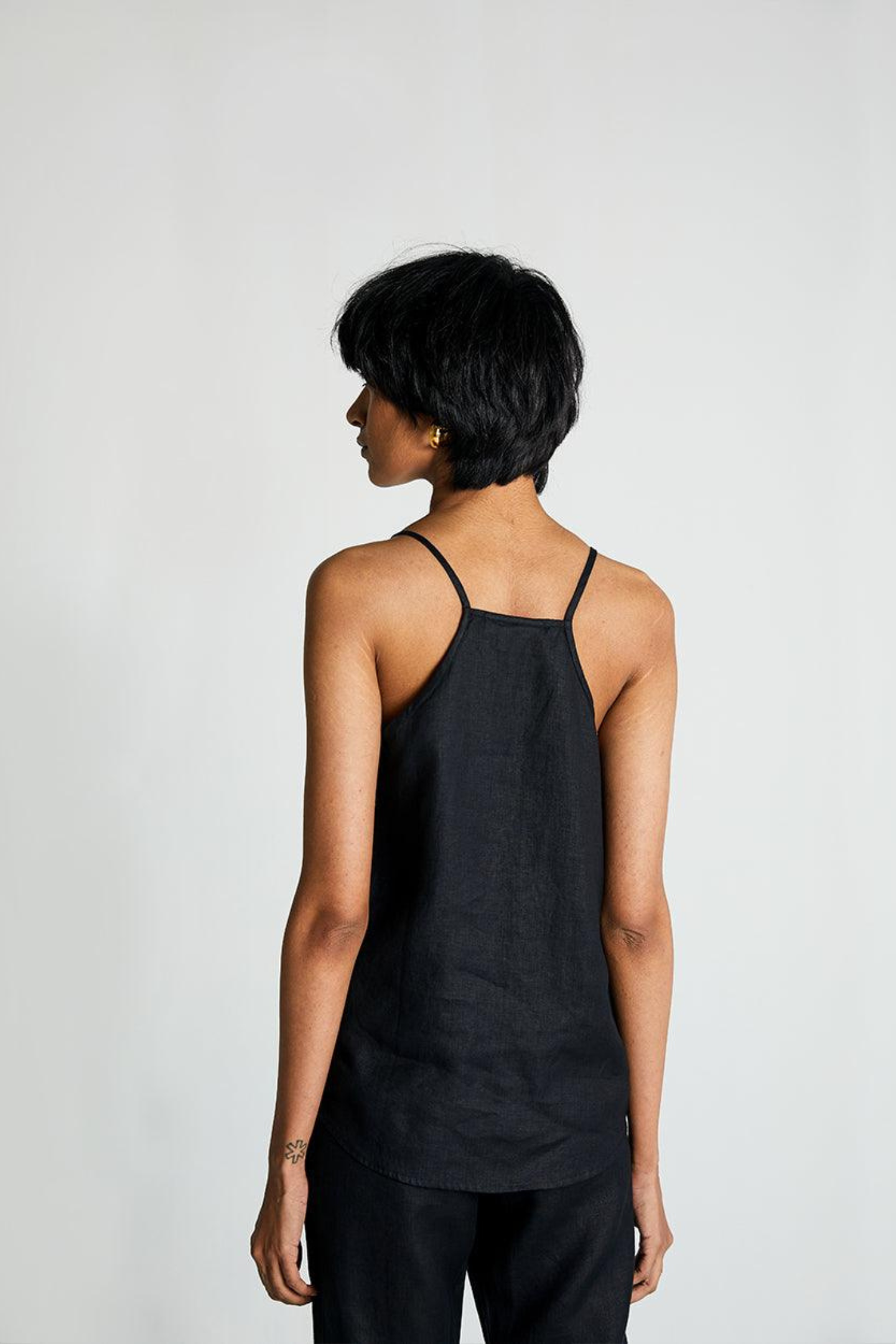 Reistor Sandcastle Saturdays Top in Black, sustainable women's camisole top with a racerback design, breathable fabric, and relaxed everyday fit. 