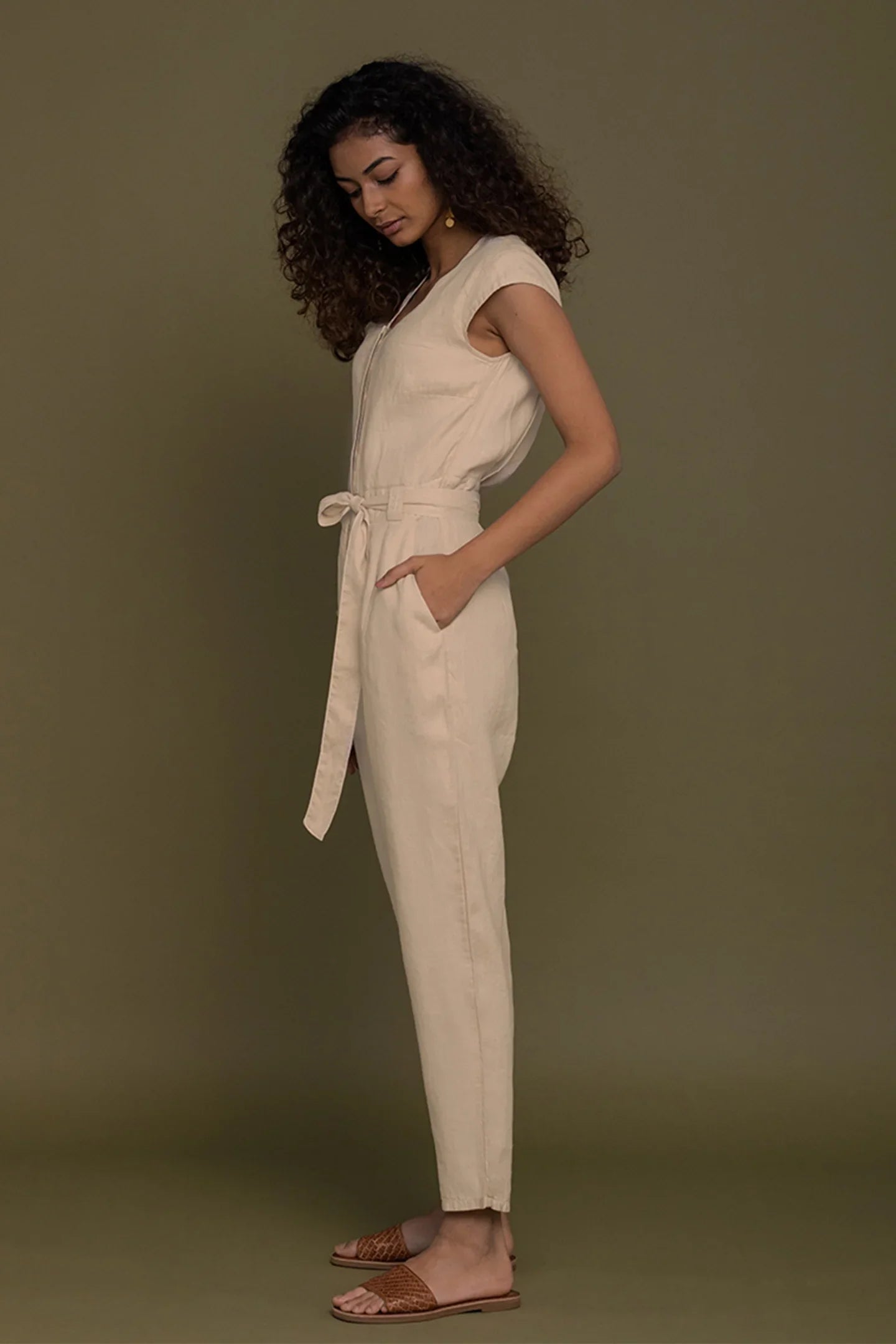 Reistor Evening Chai Jumpsuit in Neutral Beige for women, side profile with tie waist, pockets and relaxed fit