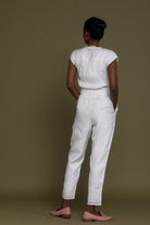 Reistor Evening Chai Jumpsuit in White showcasing the back view with a relaxed fit, tie waist, and breathable fabric