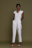 Reistor Evening Chai Jumpsuit in White with a minimalist V-neck, relaxed fit, breathable linen for effortless style