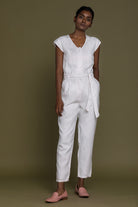 Reistor Evening Chai Jumpsuit in White featuring a relaxed fit, cap sleeves and breathable linen for timeless elegance