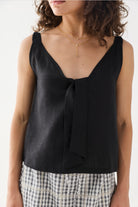 Close-up view of the Hemp Front Tie Cami Top in Black, featuring a V-neckline, elegant front tie detail, and a relaxed fit. The lightweight hemp fabric drapes softly for a comfortable, breathable feel.