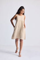 Full-length view of model wearing Reistor Hemp Short Dress with Back Embroidered Lace Detail in a neutral beige shade, sleeveless silhouette with a relaxed fit.