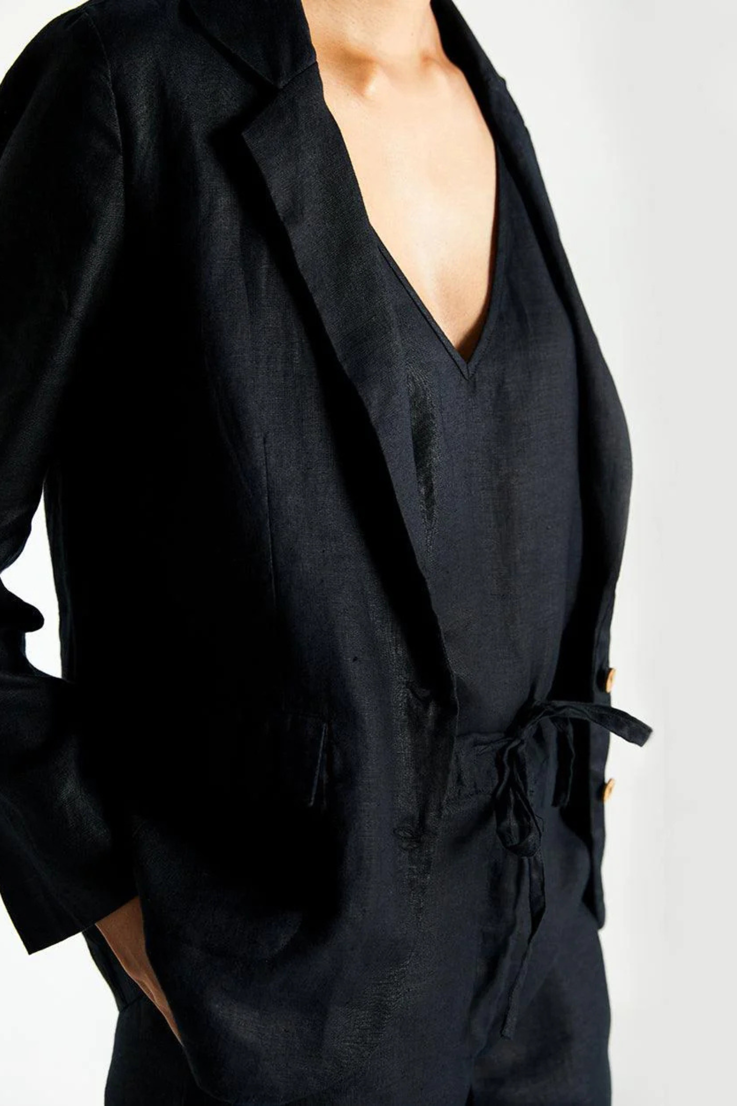 Black jumpsuit with a deep neckline on a white background