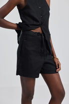 Rear view of a model wearing the reistor Hemp Vest Jacket Set in Black, showcasing the clean sleeveless silhouette of the vest and the tailored fit of the matching sustainable hemp shorts.