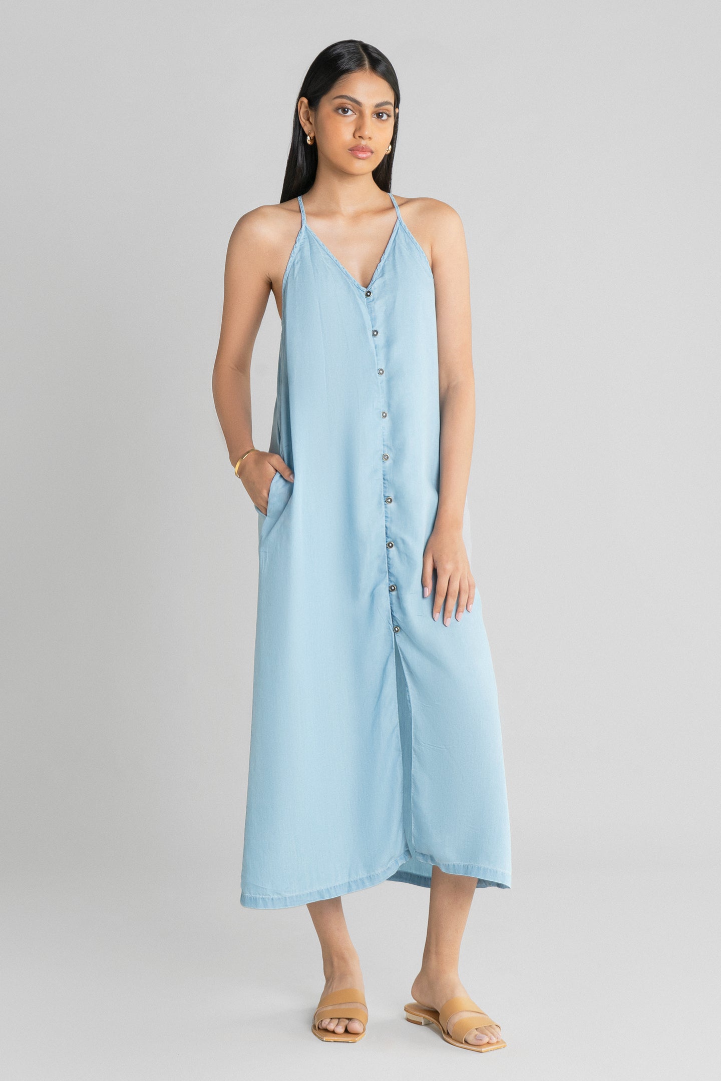 Reistor In the Mood for Love Denim Midi Dress featuring a relaxed sleeveless fit, premium lightweight denim, button-front styling and a graceful midi length.