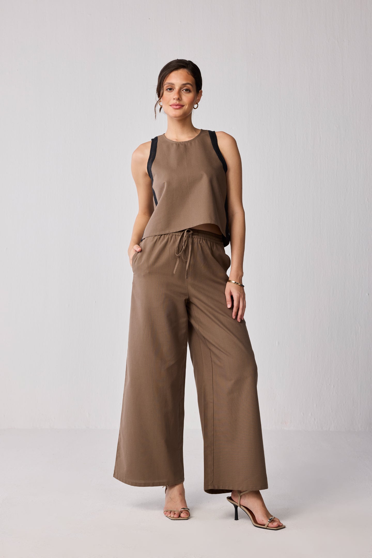 Front view of brown and black colorblock top paired with matching brown wide-leg drawstring pants