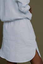 Meet Me by the Cliff Dress in Blue by Reistor, close-up back view with curved hem and side slit on a blue shirt dress