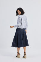 reistor Oversized Boxy-fit Shirt in Animal Print, back view on model styled with denim midi skirt and wedge heels