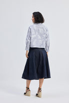 reistor Oversized Boxy-fit Shirt in Animal Print, back view styled with denim midi skirt and wedge sandals