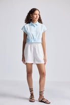 Front view of the reistor Oversized Crop Shirt in Summer Blue, a button-up organic cotton top with a relaxed, cropped fit.