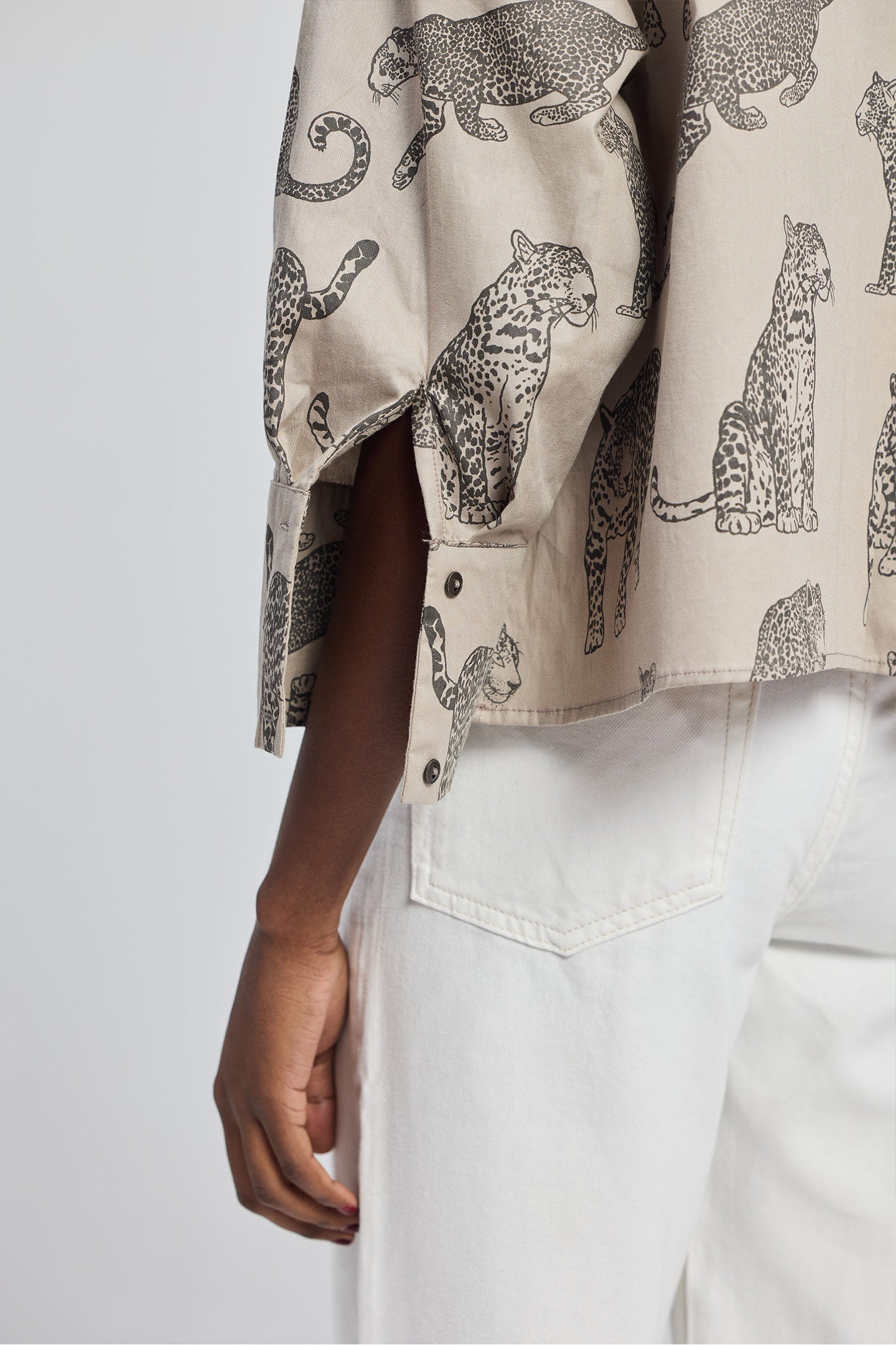 Detailed front view of the Reistor Oversized Cropped Button-down Shirt In Animal Print showing the straight collar, front pocket, and button-down detail.