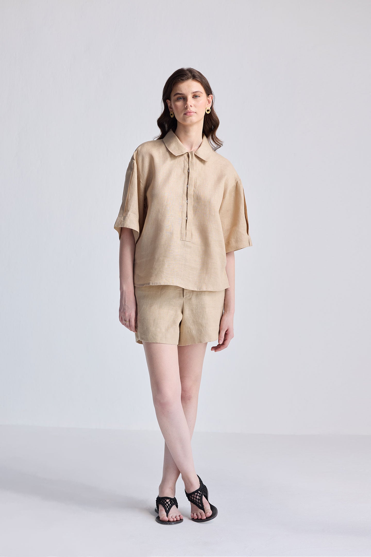 Woman wearing Oversized Flowy Shirt in Neutral Beige by reistor on white background