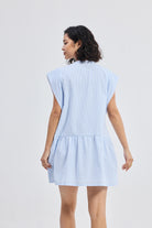 Back view model wearing Reistor Oversized V Neck Short Dress with Frayed Sleeves in blue, relaxed oversized short dress for women with loose fit