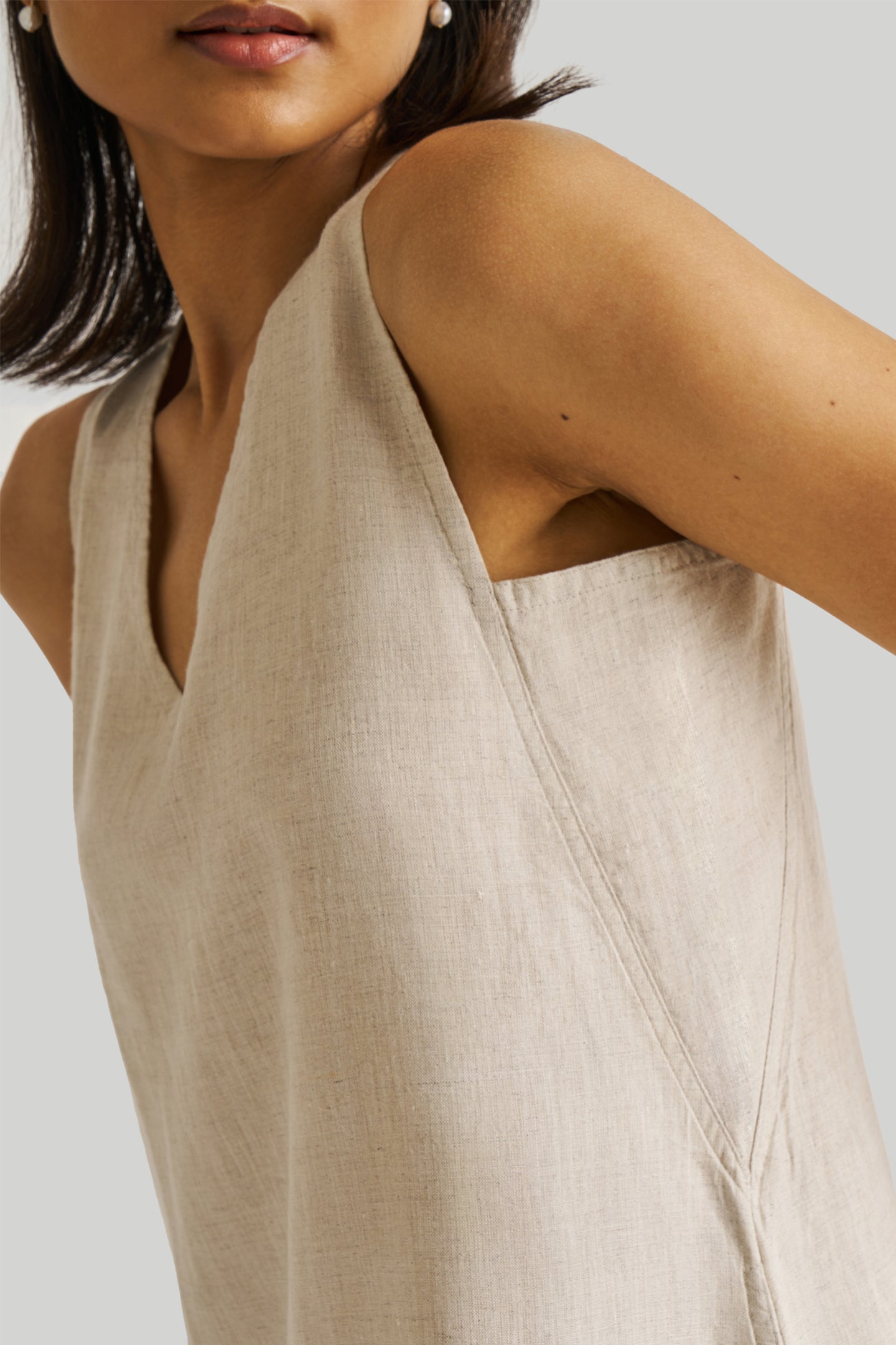 Reistor Reading Tea Leaves Dress in Ecru featuring a sleeveless V-neck design, breathable sustainable fabric, relaxed fit, and elegant minimalist style.