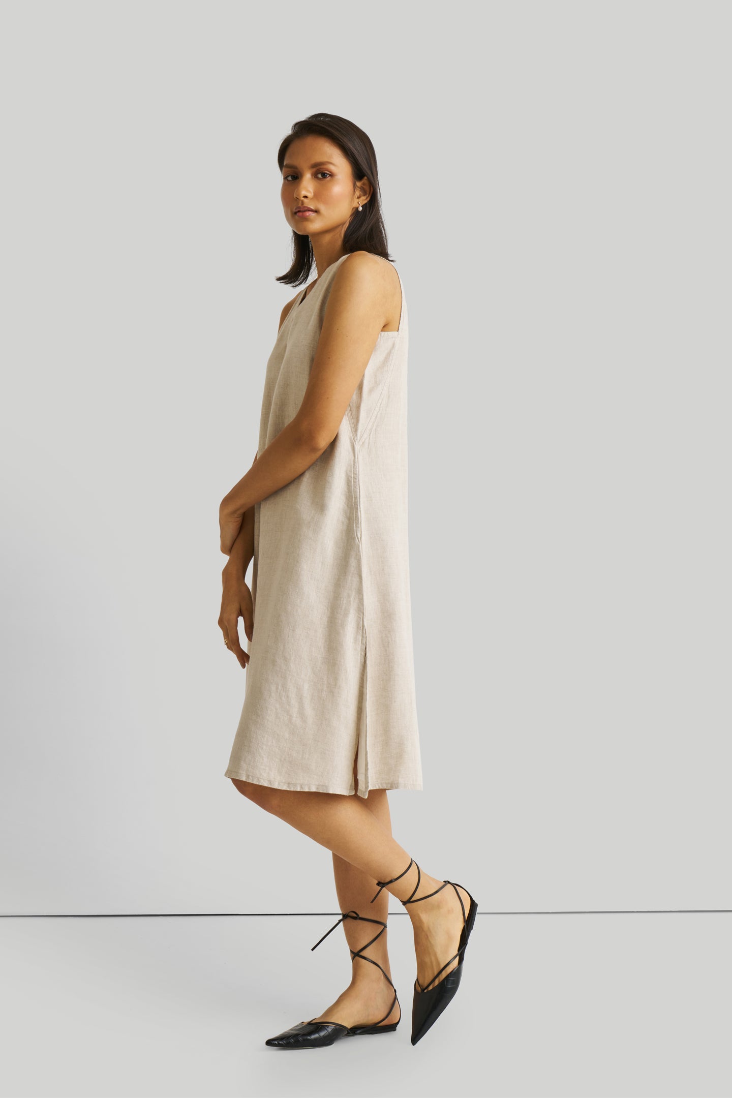 Reistor Reading Tea Leaves Dress in Ecru, sustainable sleeveless V-neck midi dress with side slits, breathable fabric, relaxed fit, and elegant style.