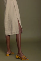 Detail view of Reistor Reading Tea Leaves Dress in Neutral Beige, showcasing the side slit and midi-length design.