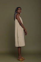 Side view of Reistor Reading Tea Leaves Dress in Neutral Beige, sleeveless V-neck midi dress for women.