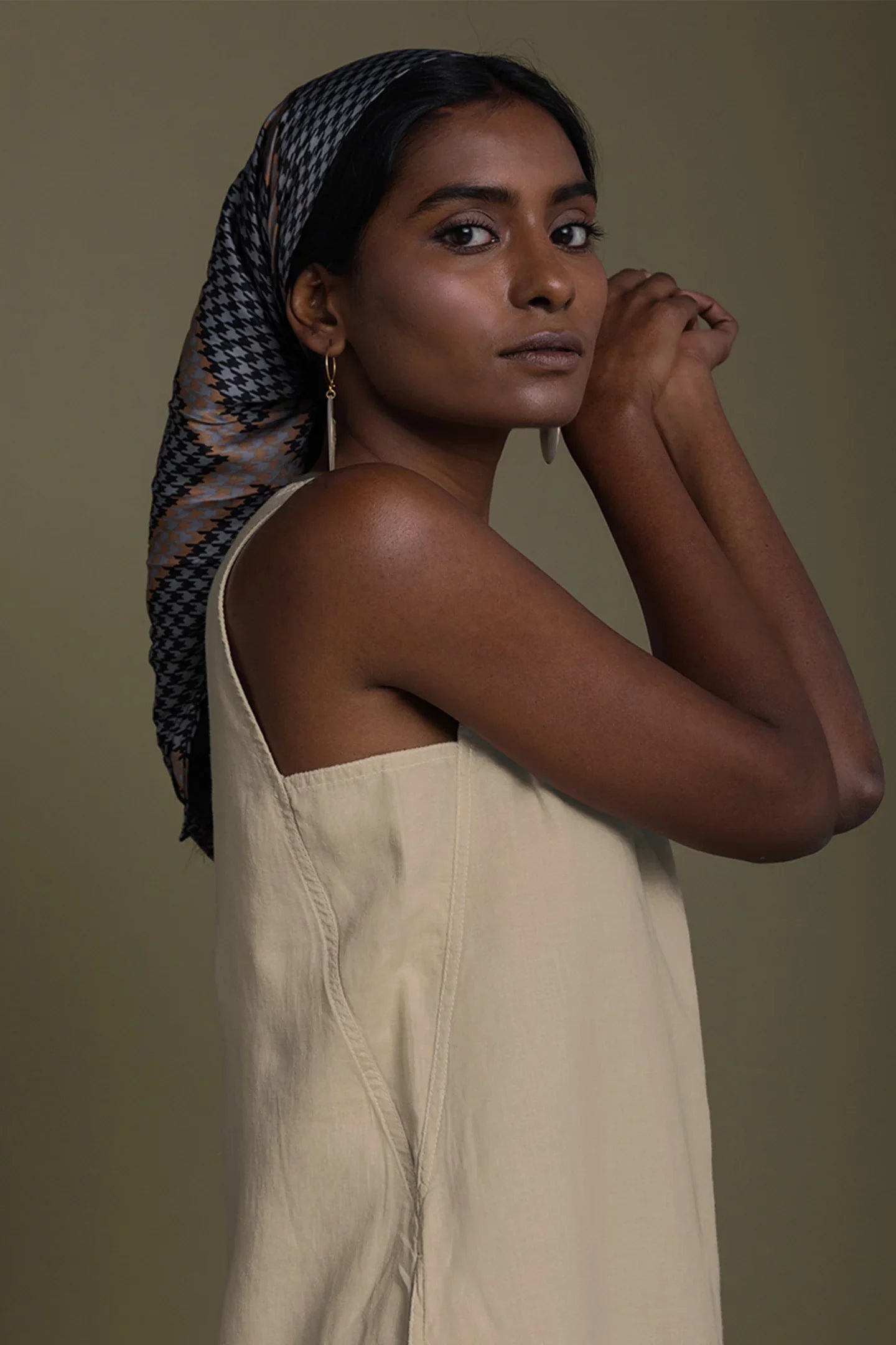 Close-up of Reistor Reading Tea Leaves Dress in Neutral Beige, sleeveless V-neck midi dress with relaxed fit.