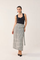 Front view of Reistor Regular Sweetheart Neck Top in Black paired with a black and white patterned midi skirt.