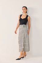 reistor Regular Sweetheart Neck Top in Black styled with a monochrome geometric wrap skirt, featuring a flattering fitted silhouette and elegant sleeveless design.