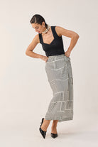 reistor Regular Sweetheart Neck Top in Black with a gathered sweetheart neckline, styled with a geometric print midi skirt for a modern elegant look.