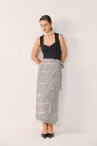 Model wearing Reistor's Regular Sweetheart Neck Top in Black, styled with geometric print wide-leg pants and pointed heels.