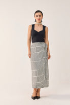 Reistor Regular Sweetheart Neck Top in Black styled with a monochrome geometric wrap skirt, offering a polished, modern look with timeless elegance.