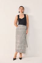 Reistor Regular Sweetheart Neck Top in Black paired with a striking geometric wrap skirt, delivering an elegant, contemporary silhouette for versatile styling.