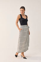 Reistor Regular Sweetheart Neck Top in Black with a black and white printed wrap skirt.