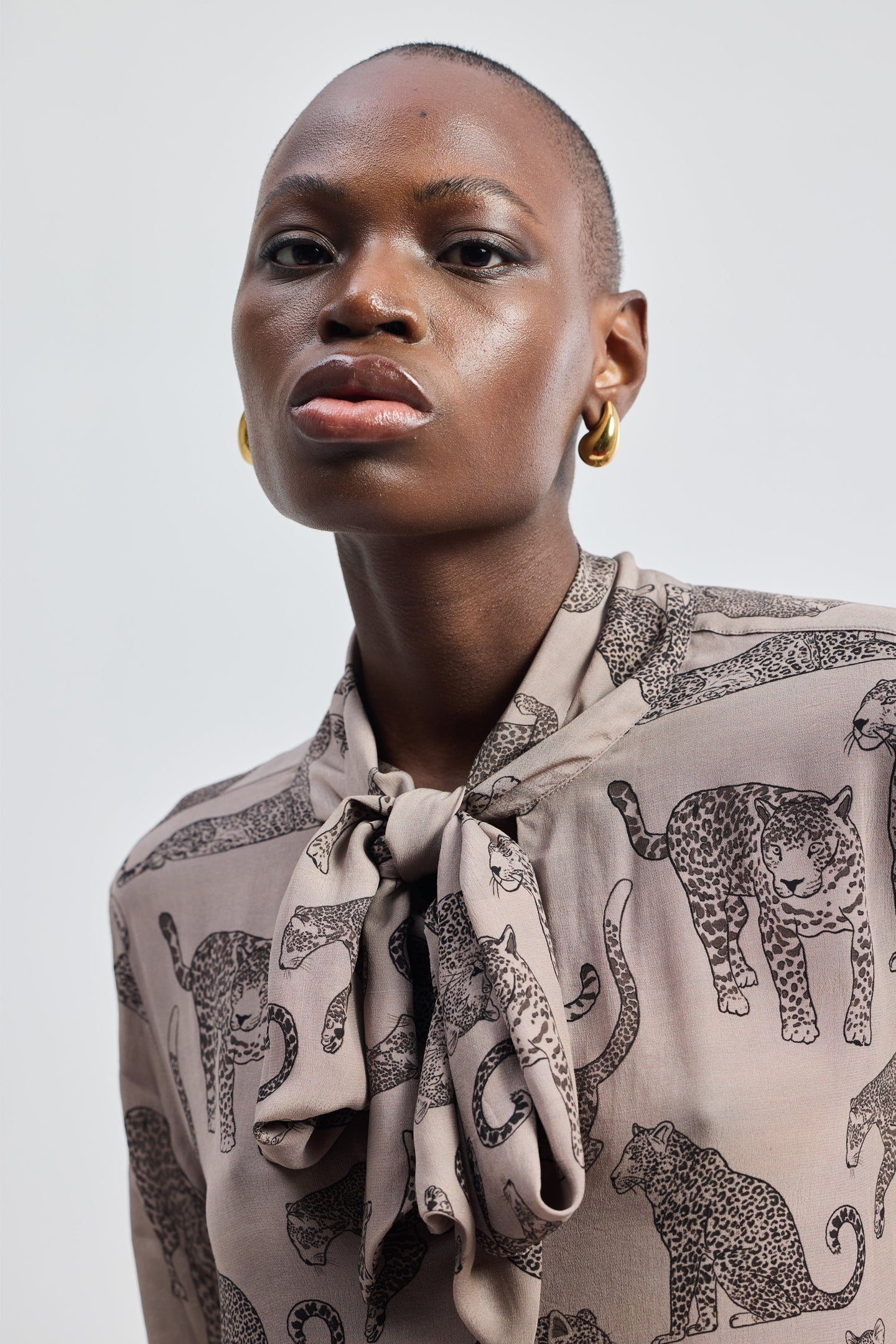 Reistor Relaxed-Fit Top with Front-tie in Animal Print, a sustainable V-neck long-sleeve top featuring a handcrafted animal pattern.