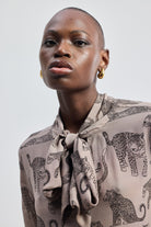 Reistor Relaxed-Fit Top with Front-tie in Animal Print, a sustainable V-neck long-sleeve top featuring a handcrafted animal pattern.