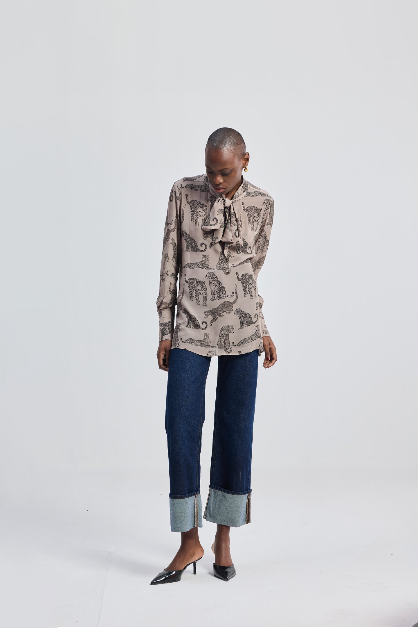 Relaxed-Fit Top with Front-tie in Animal Print by reistor, shown on a model wearing a neutral animal print top paired with dark denim jeans in a clean studio background.