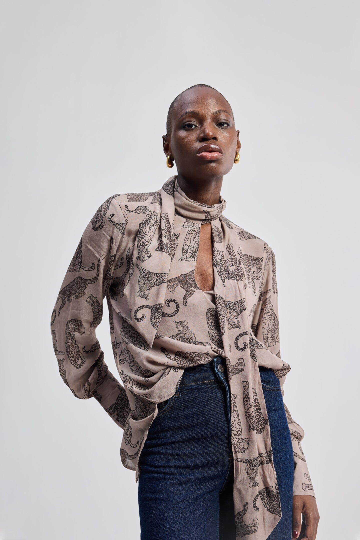 Relaxed-Fit Top with Front-tie in Animal Print by reistor, featuring a lightweight long-sleeve blouse with a front tie detail, neutral animal pattern, and a relaxed, modern silhouette.